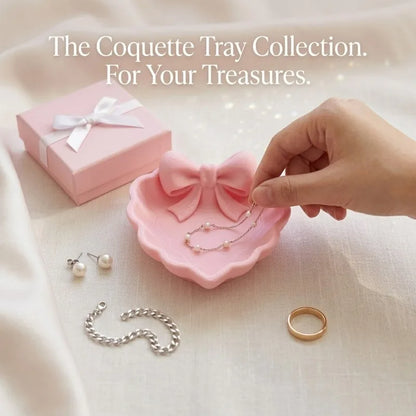 A heart-shaped jewelry tray with a pink bow, made using 3D printing technology, is suitable for placement on a dressing table, s