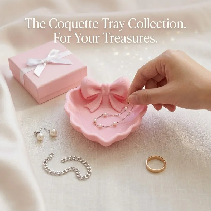A heart-shaped jewelry tray with a pink bow, made using 3D printing technology, is suitable for placement on a dressing table, s